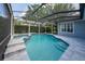 Screened-in pool with spa, tiled decking, and lush landscaping for ultimate relaxation at 8374 Bowden Way, Windermere, FL 34786