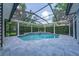 Screened-in pool with spa, tiled decking, and lush landscaping for ultimate relaxation at 8374 Bowden Way, Windermere, FL 34786