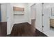 Walk-in closet with wood-look flooring, custom shelving, and convenient access to the bathroom at 8374 Bowden Way, Windermere, FL 34786
