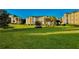 Expansive green lawn view of sunny apartment buildings with palm trees at 8907 Legacy Ct # 14 205, Kissimmee, FL 34747