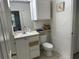 A well-lit bathroom with a vanity, toilet, and linen closet at 8907 Legacy Ct # 14 205, Kissimmee, FL 34747