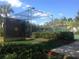 Outdoor batting cage surrounded by lush landscaping and partial view of the community tennis courts at 8907 Legacy Ct # 14 205, Kissimmee, FL 34747