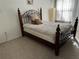 Bedroom features a decorative iron bed frame and neutral decor for a relaxing atmosphere at 8907 Legacy Ct # 14 205, Kissimmee, FL 34747