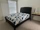 Bedroom featuring a bed with a patterned quilt and vanity with large mirror at 8907 Legacy Ct # 14 205, Kissimmee, FL 34747