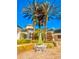 Clubhouse with beautiful landscaping, palm trees, table and chairs for outdoor relaxation and blue skies at 8907 Legacy Ct # 14 205, Kissimmee, FL 34747