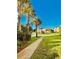 Scenic view of community buildings lined by palm trees and a smooth sidewalk at 8907 Legacy Ct # 14 205, Kissimmee, FL 34747