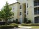 A well-maintained apartment building with lush landscaping and ample parking at 8907 Legacy Ct # 14 205, Kissimmee, FL 34747