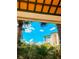 Lush tropical greenery framing a picturesque view of a building with blue skies and fluffy clouds at 8907 Legacy Ct # 14 205, Kissimmee, FL 34747