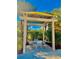The cabana offers a charming outdoor seating area surrounded by lush greenery and sunny skies at 8907 Legacy Ct # 14 205, Kissimmee, FL 34747
