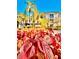 Vibrant red landscaping with palm trees creating a serene and picturesque setting at 8907 Legacy Ct # 14 205, Kissimmee, FL 34747
