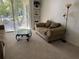 A comfortable living area with a love seat, coffee table, and access to the balcony at 8907 Legacy Ct # 14 205, Kissimmee, FL 34747