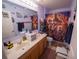 Bathroom with double sinks, a large mirror, and an 'Avengers' themed shower curtain at 905 Gloucester Ct, Kissimmee, FL 34758