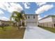 Charming two-story home featuring a well-maintained front yard with a palm tree and inviting curb appeal at 905 Gloucester Ct, Kissimmee, FL 34758