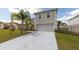 Two-story home with a two car garage, long driveway, and a well kept lawn at 905 Gloucester Ct, Kissimmee, FL 34758