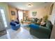 Comfortable living room featuring tile flooring, a large window, and a cozy seating arrangement at 905 Gloucester Ct, Kissimmee, FL 34758