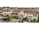 Aerial view of townhomes featuring well-maintained landscaping, private entrances, and convenient parking at 9075 Dogleg Dr, Davenport, FL 33896