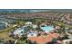 Overhead view of the community featuring lush landscaping, walking paths, and multiple swimming pools at 9075 Dogleg Dr, Davenport, FL 33896