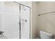 Bathroom featuring a shower with white tiling and a glass door at 9075 Dogleg Dr, Davenport, FL 33896