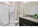 Bathroom featuring a glass-enclosed shower and granite vanity at 9075 Dogleg Dr, Davenport, FL 33896