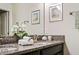 Bathroom vanity featuring granite countertops and dual sinks at 9075 Dogleg Dr, Davenport, FL 33896