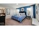 Bedroom with blue accent wall, white closet and lots of natural light at 9075 Dogleg Dr, Davenport, FL 33896
