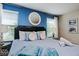 Bedroom with blue accent wall, white curtains and many decorative pillows at 9075 Dogleg Dr, Davenport, FL 33896