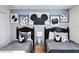 Fun bedroom with two twin beds with blue accents and Mickey Mouse themed decor at 9075 Dogleg Dr, Davenport, FL 33896