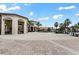 Beautiful clubhouse featuring an open-air dining area, community fountain, and lush tropical landscaping at 9075 Dogleg Dr, Davenport, FL 33896