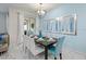Stylish dining room with modern lighting, seating for eight, and patio access at 9075 Dogleg Dr, Davenport, FL 33896