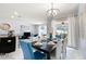 Bright dining area with elegant chandelier and sliding glass doors to outdoor space at 9075 Dogleg Dr, Davenport, FL 33896