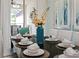 Dining table set with elegant white place settings and centerpiece at 9075 Dogleg Dr, Davenport, FL 33896