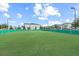 Dog park with artificial turf and perimeter fencing surrounded by green landscaping at 9075 Dogleg Dr, Davenport, FL 33896