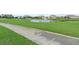 Scenic golf course view with a pond, fountain, and lush green fairways at 9075 Dogleg Dr, Davenport, FL 33896