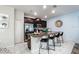 Modern kitchen island with sink and granite countertops, and seating for four at 9075 Dogleg Dr, Davenport, FL 33896