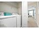 A well-equipped laundry room with modern appliances and convenient shelving in a well lit area at 9075 Dogleg Dr, Davenport, FL 33896