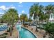 A lazy river winds through palm trees, providing a relaxing and scenic amenity for all residents at 9075 Dogleg Dr, Davenport, FL 33896