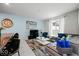 Open-plan living room with integrated kitchen, dining, and backyard views at 9075 Dogleg Dr, Davenport, FL 33896