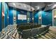 Community movie theater with comfortable seating, projector, and a large screen at 9075 Dogleg Dr, Davenport, FL 33896