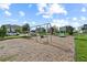 Community playground area with swings and climbing structures on a sunny day at 9075 Dogleg Dr, Davenport, FL 33896