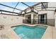 Inviting screened-in pool area with comfortable patio seating and a safety fence at 9075 Dogleg Dr, Davenport, FL 33896
