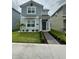 Charming two-story home with a well-manicured lawn, tidy landscaping, and a welcoming walkway at 11312 Listening Dr, Orlando, FL 32832