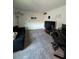 Game room furnished with a black couch, gaming accessories, and decorative wall art at 11312 Listening Dr, Orlando, FL 32832