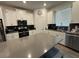 Modern kitchen featuring white cabinets, stainless steel appliances, and a large center island at 11312 Listening Dr, Orlando, FL 32832