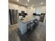 Well-lit kitchen with white cabinetry, a center island with seating, and stainless steel appliances at 11312 Listening Dr, Orlando, FL 32832