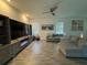 Comfortable living area with modern furniture, a large television, and natural light from windows at 11312 Listening Dr, Orlando, FL 32832