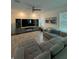 Spacious living room with a large sectional sofa, media console, and a ceiling fan at 11312 Listening Dr, Orlando, FL 32832