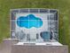 Aerial view of the home's private screened-in pool area with a pool, hot tub, and outdoor seating at 107 Troon Cir, Davenport, FL 33897