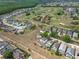 Aerial view of a golf course community showcasing numerous homes, lush green golf course and mature trees at 107 Troon Cir, Davenport, FL 33897