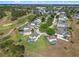 Aerial view of a community with a pool, golf course and well-manicured landscaping at 107 Troon Cir, Davenport, FL 33897