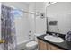 Clean bathroom featuring a shower-tub combo, neutral colors, and ample counter space at 107 Troon Cir, Davenport, FL 33897
